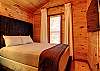 Queen bed in first bedroom of the Apple (main) cabin. 