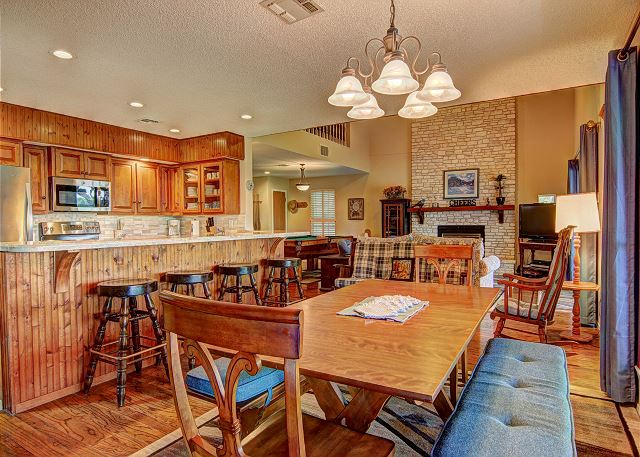 Open kitchen, dining room, living area with ample seating.