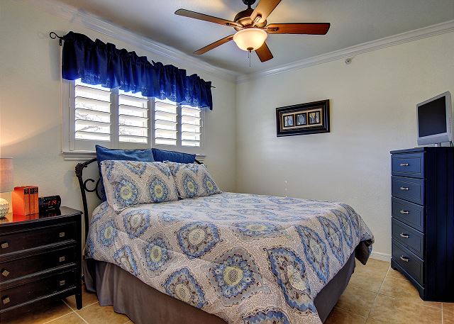 Catch some Zzz in this cool blue guest bedroom with a queen size bed!