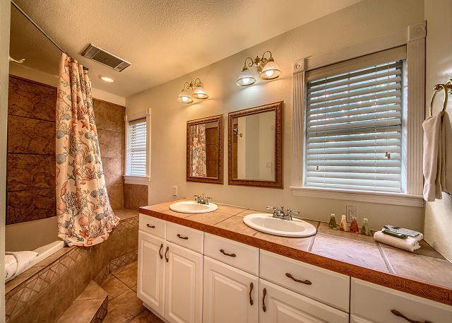Upstairs guest bath with deep tub, double sinks and convenient to both upstairs bedrooms. 