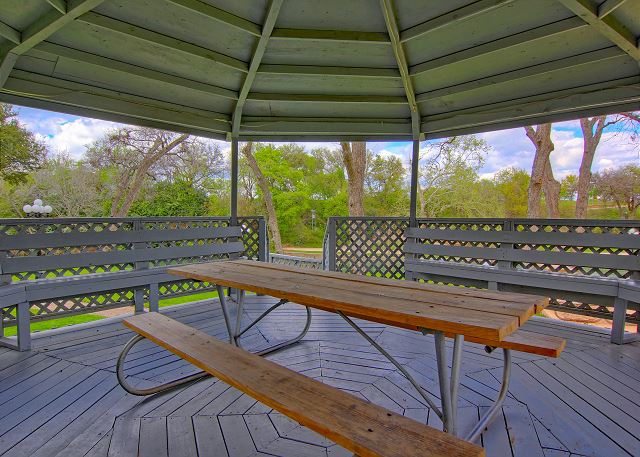 Gazebo on grounds with picnic tables and benches.