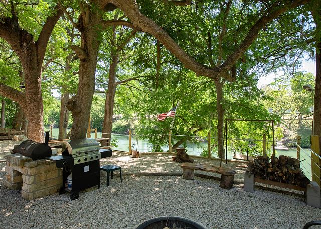 Plenty of seating outdoors with a picnic table, porch swing and lots of chairs to relax in under the big shade trees. Charcoal grill, propane grill and smoker. Fire pit to roast smores!
