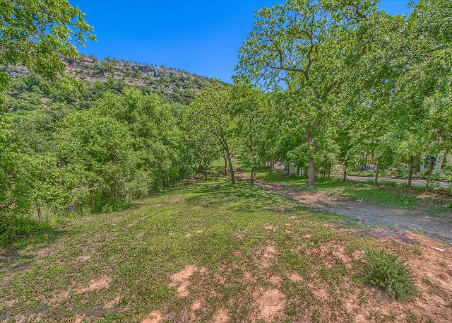 The beautiful Guadalupe River is 130 yards from the backdoor of the home, and there is a gravel road you can drive down 93 yards to alleviate some of the walking!