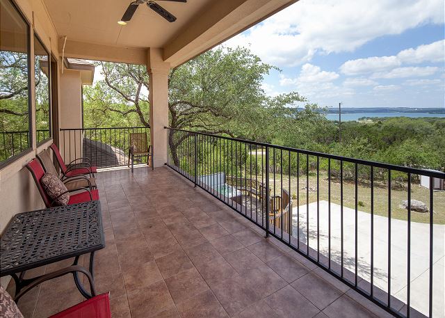 breathtaking views of the lake from the upstairs covered porch with seating and fan