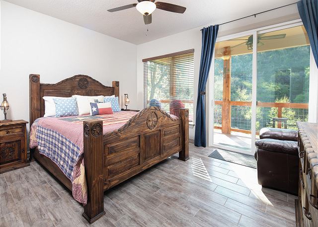 First master bedroom is right off the living room with king size bed, private porch access, river view, and en suite bathroom.