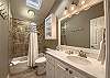 The guest bathroom is conveniently located between the 2 guest rooms.