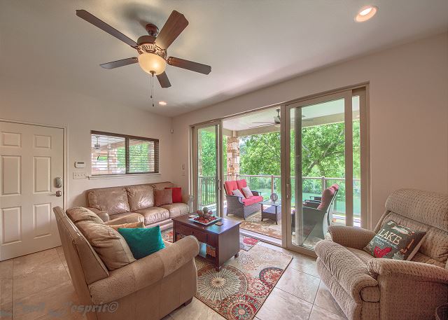 Vaulted ceilings and double sliding glass doors, that are floor to ceiling, opening out to a gorgeous patios with spectacular views of the river. 