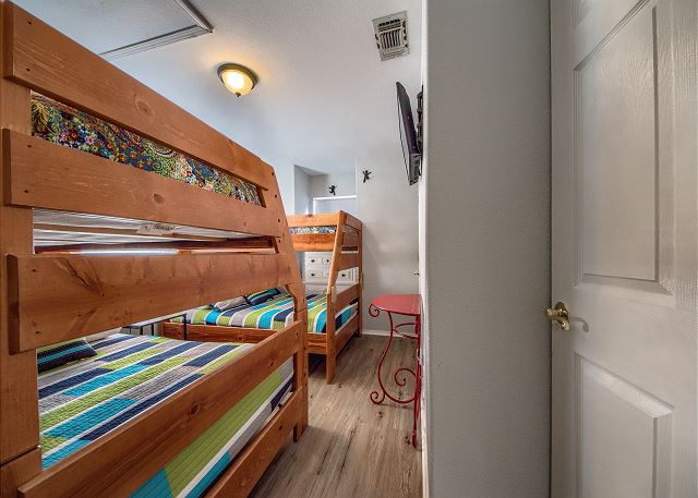 First bedroom has 2 twin over full size bunk beds. new wood laminate floors!