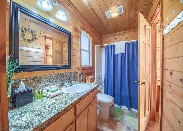 Full bathroom with a tub shower combo.