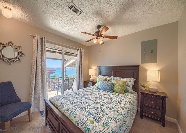 The 2nd bedroom has a queen size bed and lake views with a sliding glass door leading out to the porch. 