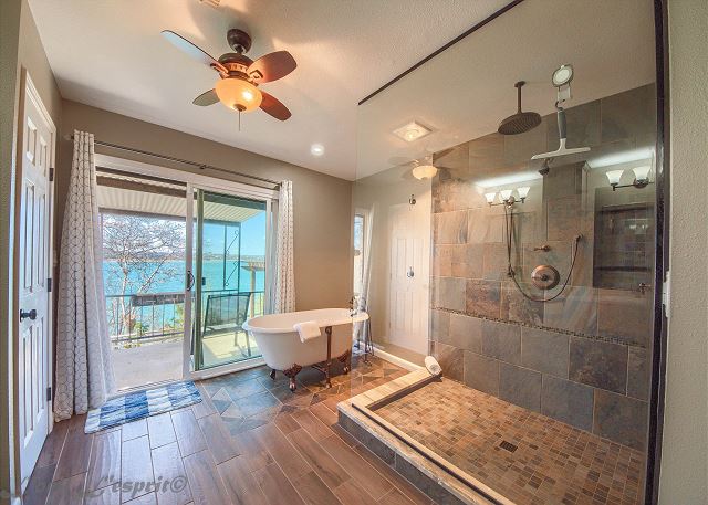 Claw foot tub and a large walk in shower, sliding glass door onto the porch and great views of the lake.