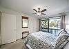Queen bed in 2nd bedroom with a view of the tennis courts