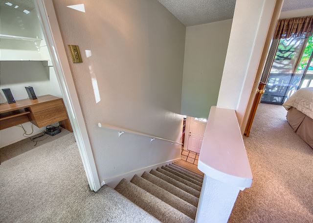 Stairs leading upstairs to second and third bedrooms.