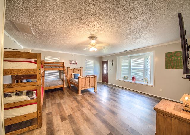 Bunk Room with 2 twin over twin bunks with another twin size bed on the main floor. 
