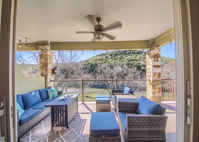 Fabulous covered patio with comfortable seating, a propane grill, and a propane glass fire pit with amazing views of the Guadalupe river!