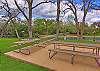 Communal picnic tables and charcoal pits