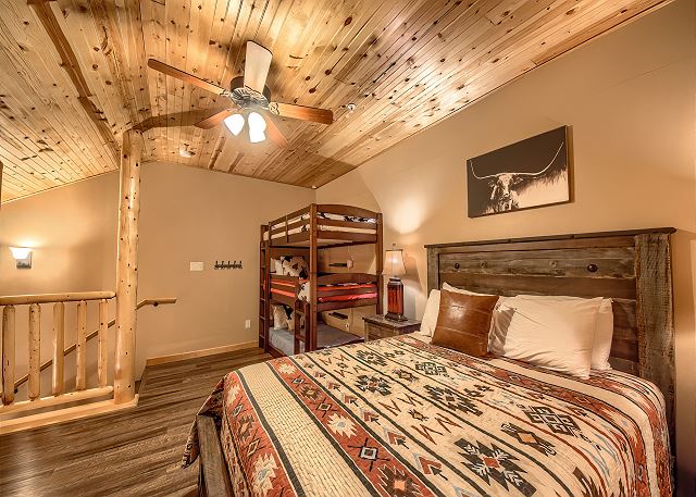 Upstairs bedroom with a Queen sized bed and bunk beds! 