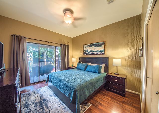 Master bedroom with king bed, access to the patio and private bathroom. 
