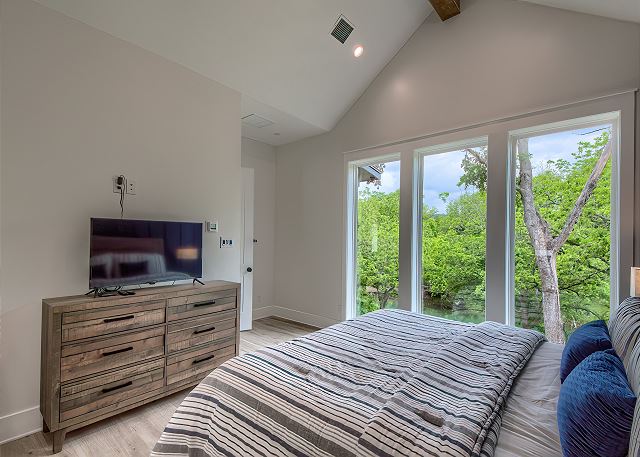 Wake up to beautiful views of the Guadalupe river right from bed! 
