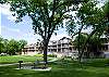 Picnic tables and communal charcoal grills on the vast green lawn under huge shade trees!