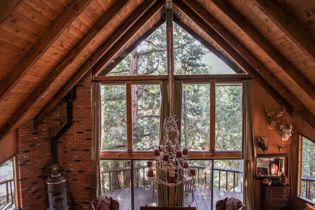 Vaulted ceilings with beams and large windows bring the outside -Original