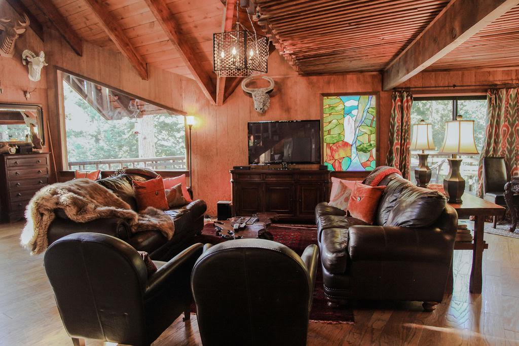 Living room with TV, perfect for a cabin movie night.-Original