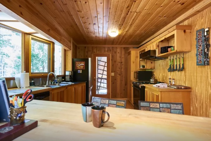 Dining room and kitchen. Kitchen is fully stocked.-Original