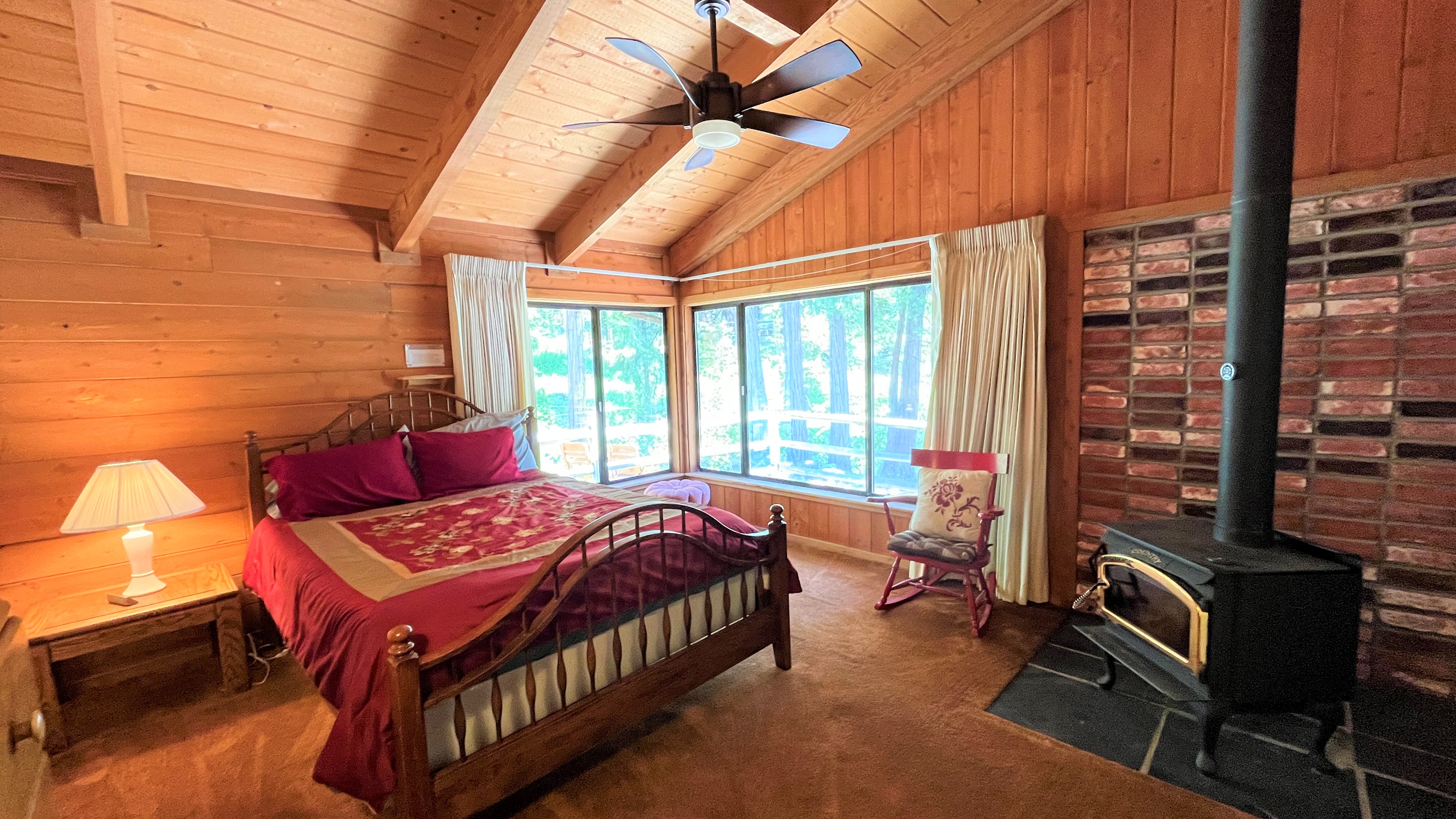 Bedroom with a queen-sized bed, wood-burning stove, and views of-Original