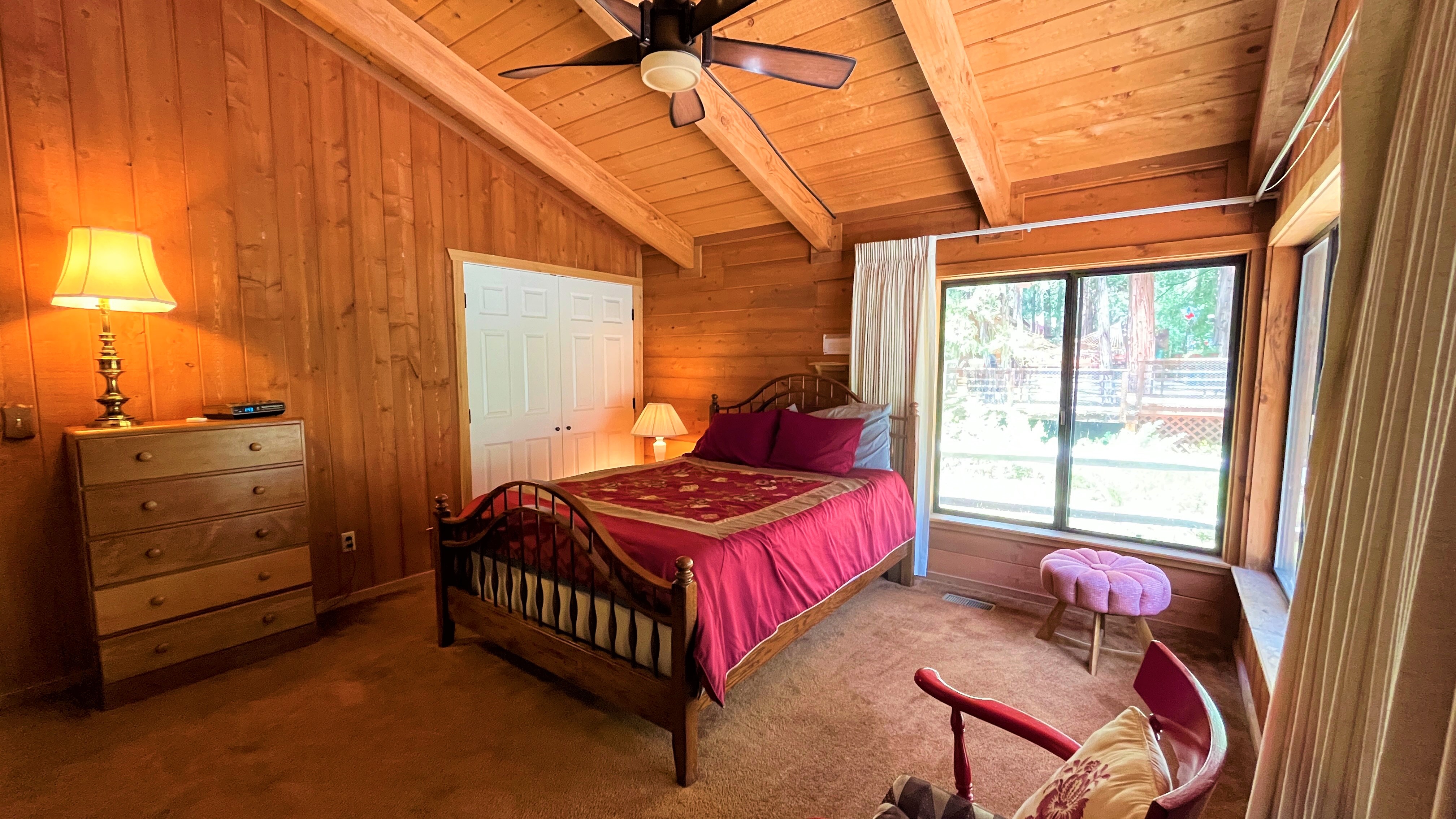 Bedroom with queen sized bed, in suite bathroom and deck access.-Original