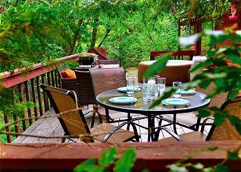 Dine outdoors with a lovely forest scenery.