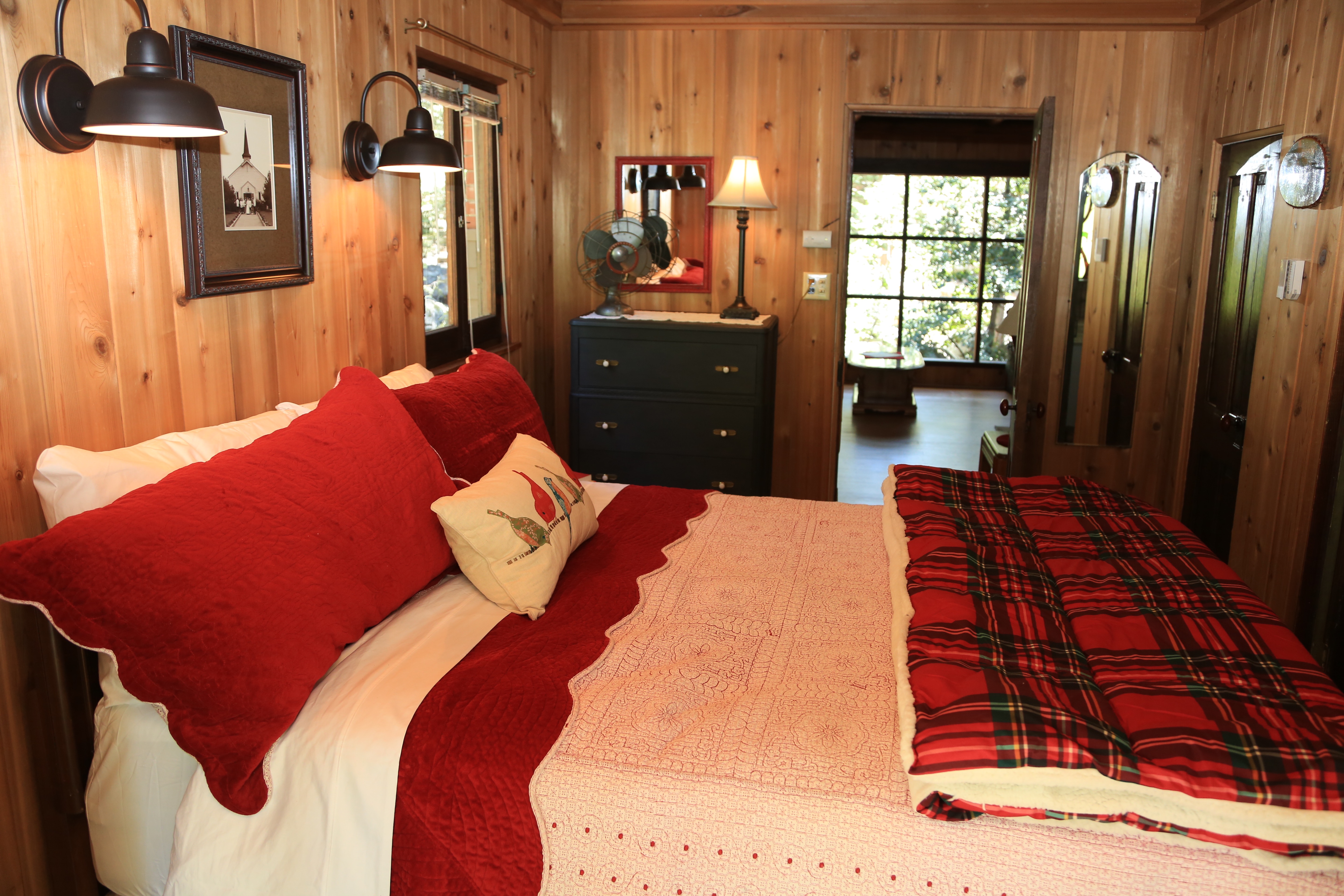 Master bedroom with queen size bed has several screened windows -Original