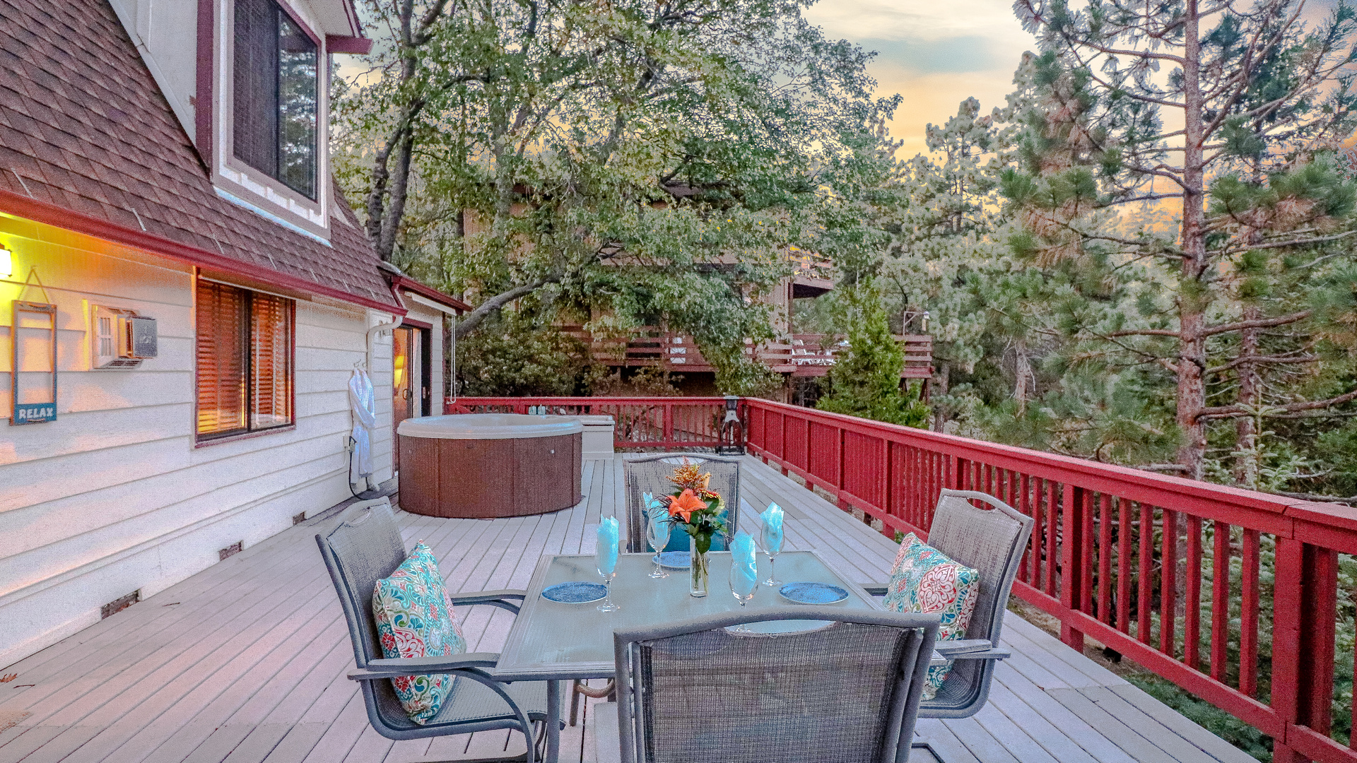 Spacious deck with outdoor seating and hot tub.-Original