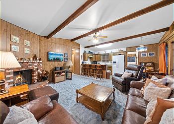 Living room with smart TV, fireplace, comfortable seating and ea