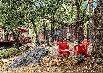 Backyard features outdoor seating throughout the property as wel