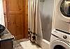 Full bathroom with laundry, sink, toilet, tub and shower