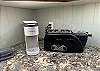 Fully stocked kitchen with appliances, utensils and serveware.