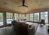 3 season porch with ample storage, seating, and gas fireplace.