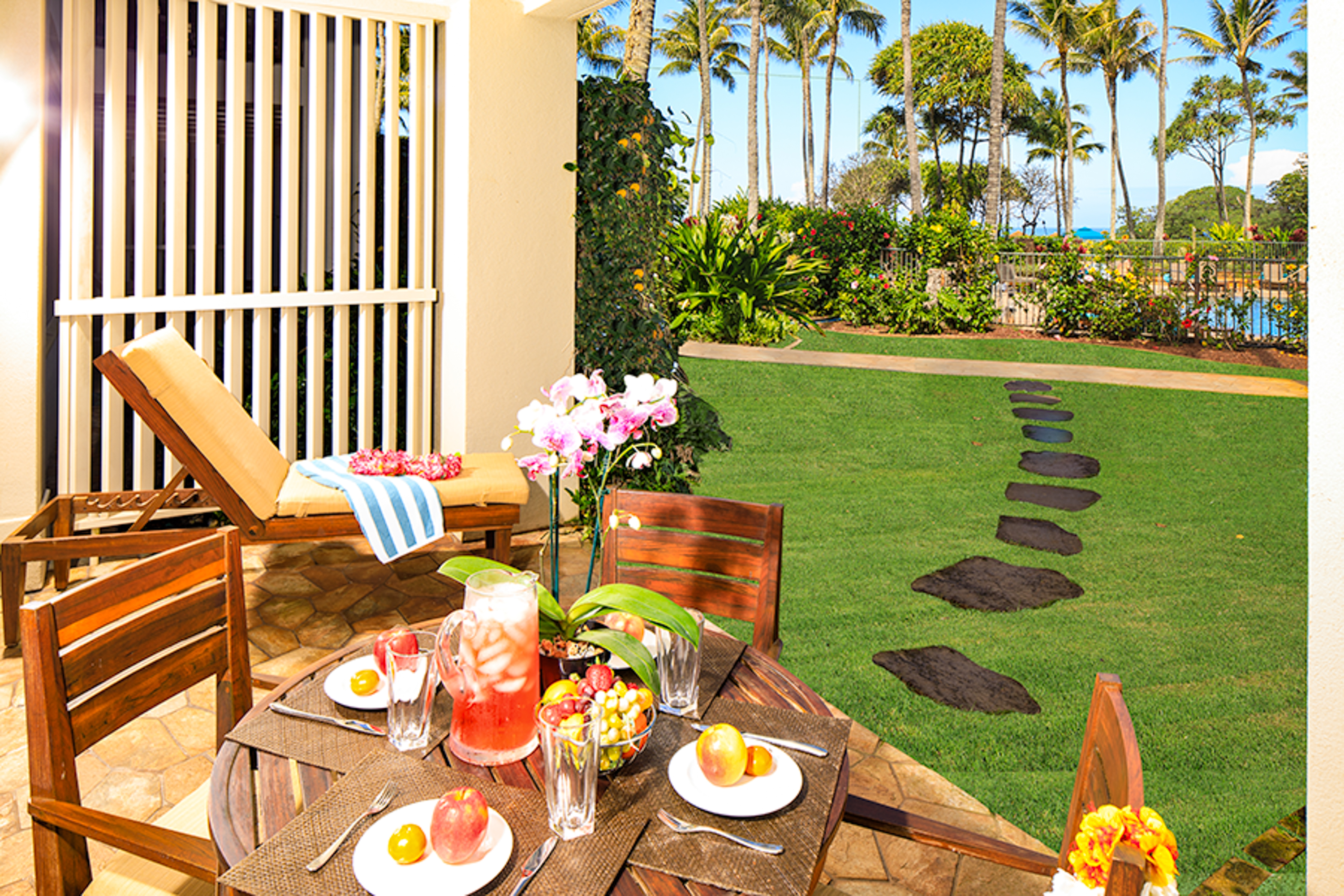 Lanai with beautiful garden, pool and ocean views, dining table, 4 chairs, chaise lounge and end table!