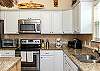 Fully equipped kitchen with stainless steel appliances and ample storage