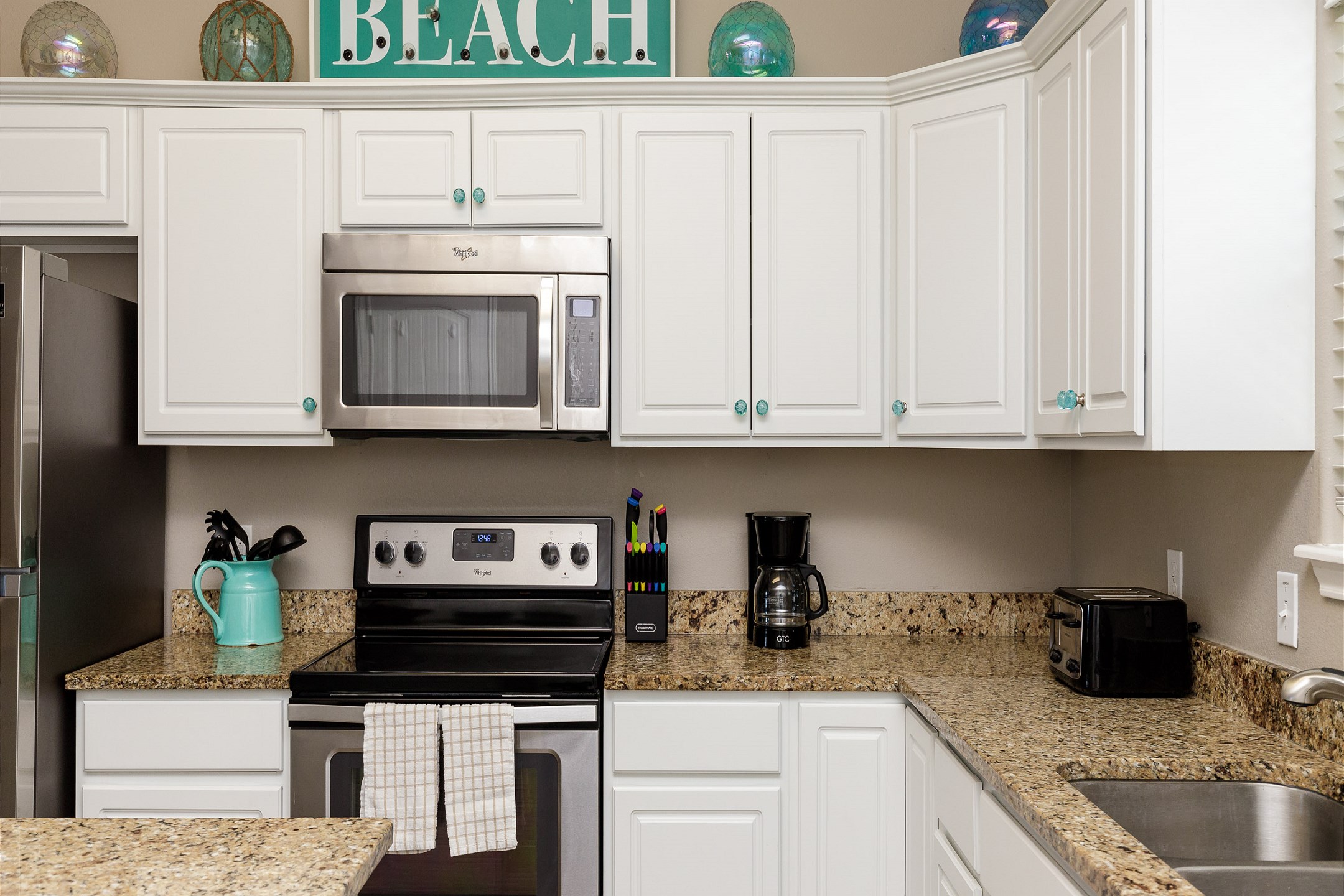 Coffee maker, toaster, cookware, dinnerware, and other kitchen essentials provided