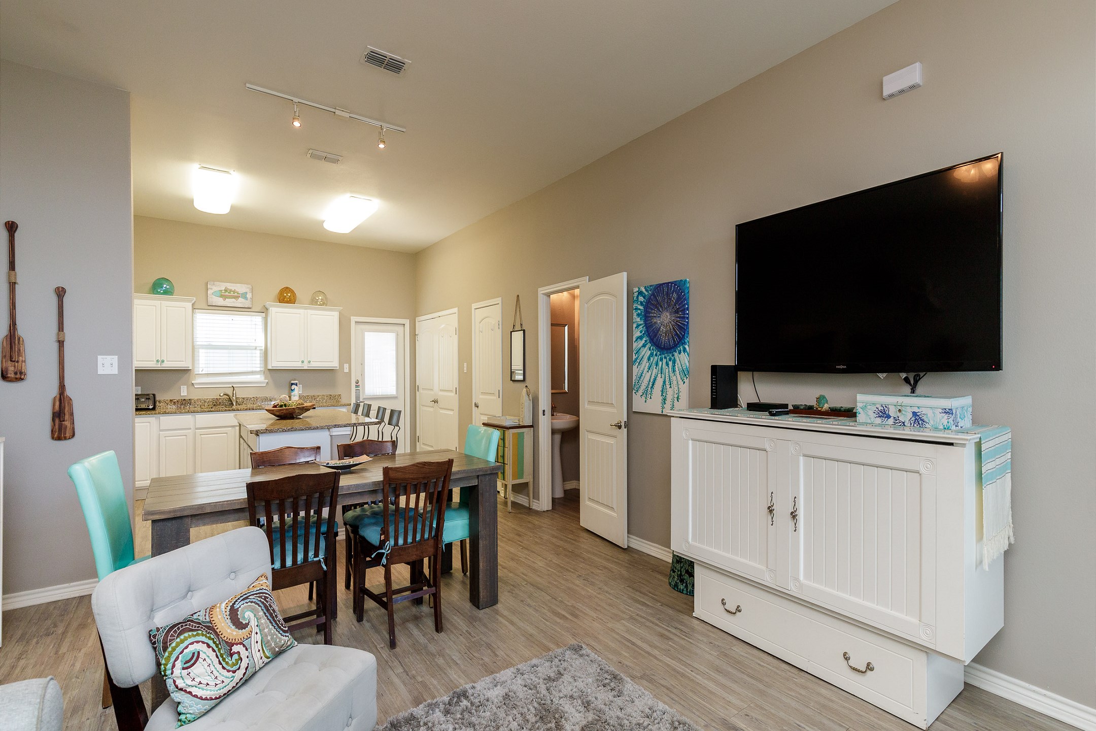 Living area entertainment center with flat-screen TV and streaming services for enjoyment after a long day of fun in the sun