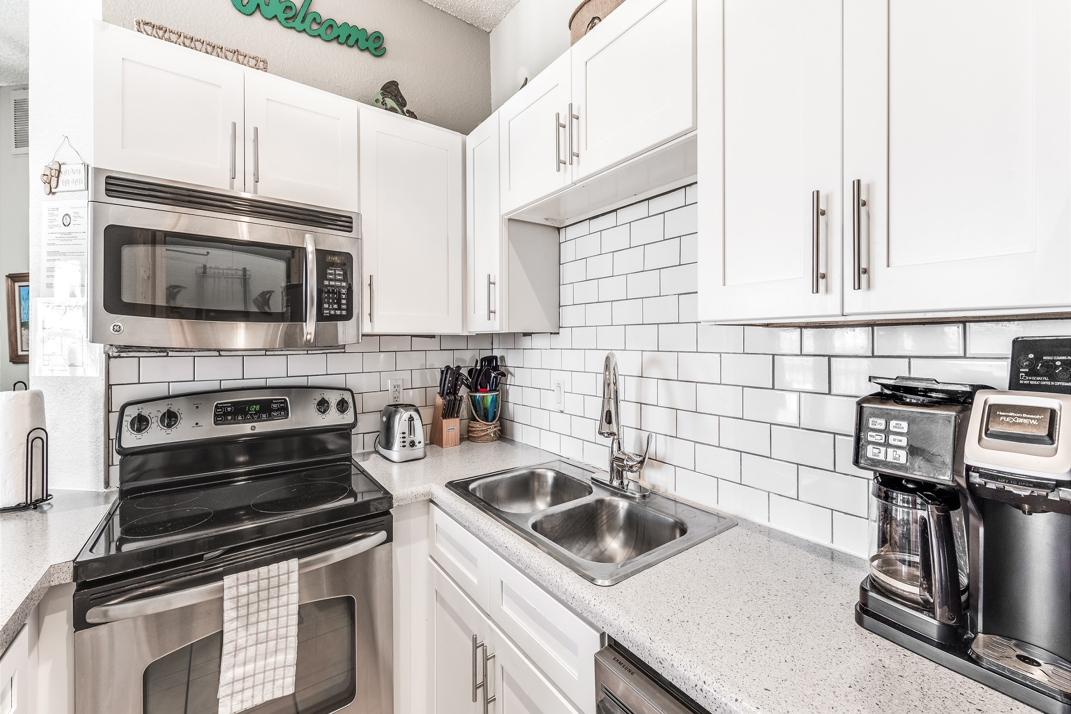 Coffee maker, toaster, cookware, dinnerware, and other kitchen essentials provided