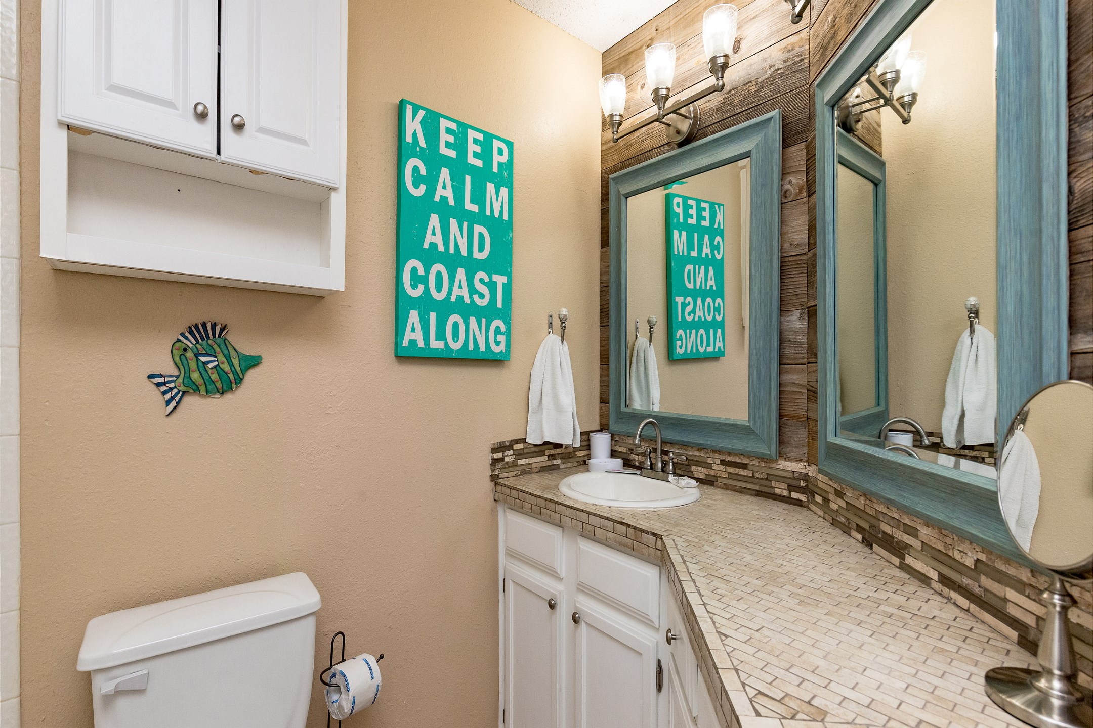 Full bathroom with ample counter space and storage