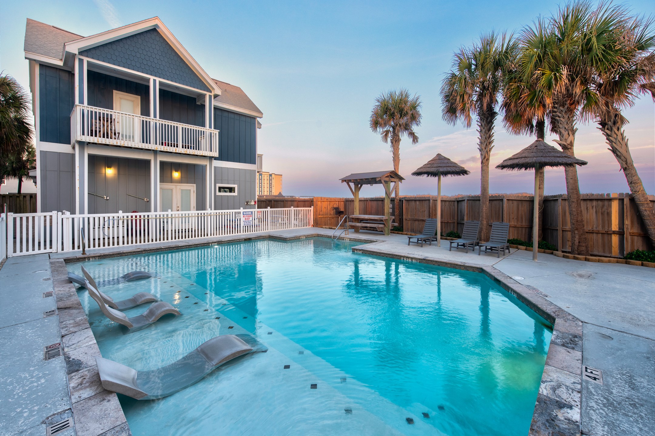 Experience luxury at the stunning heated pool with in water loungers, Tiki huts and picnic tables