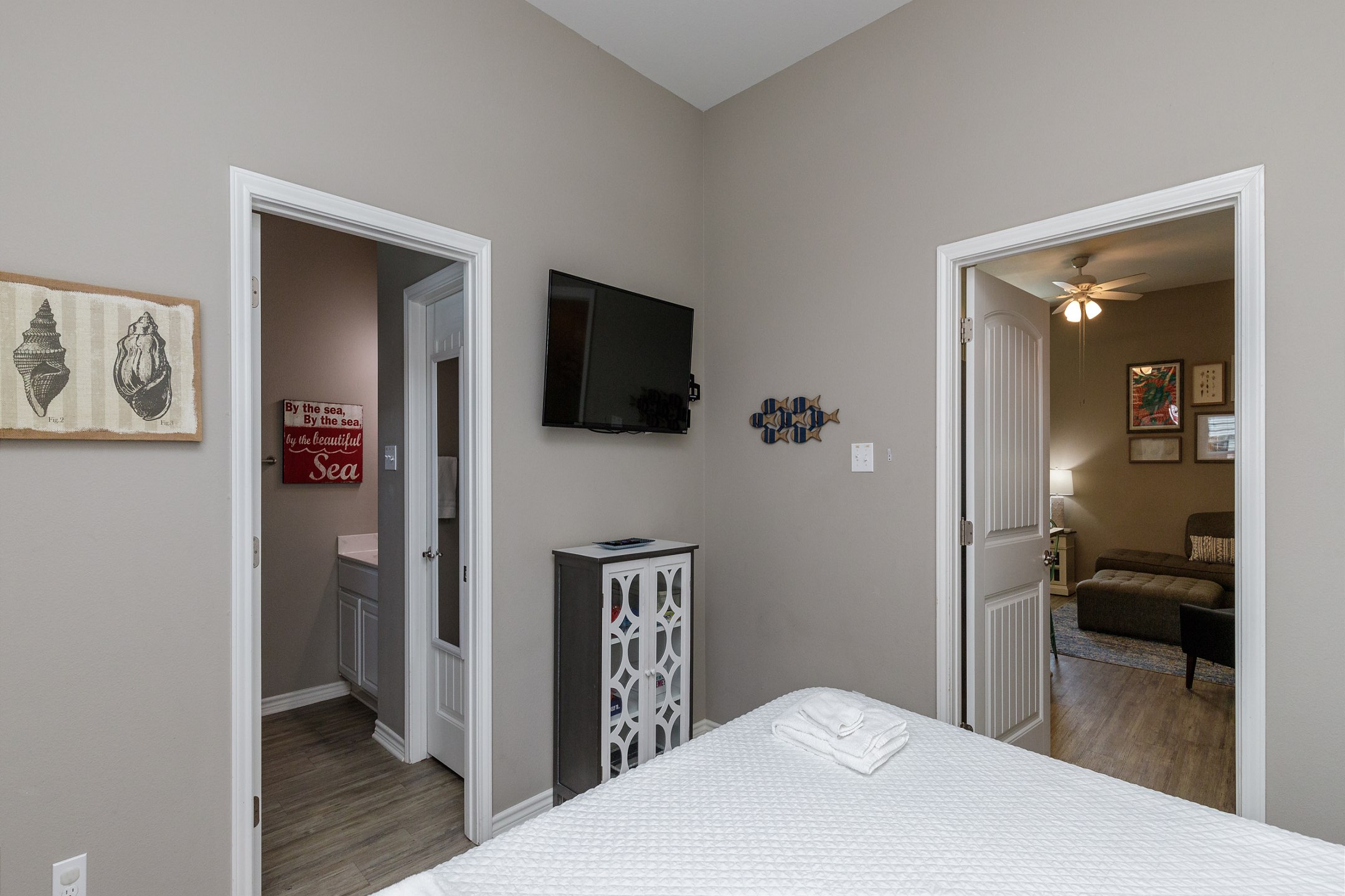 Master bedroom on the first floor with a king size bed, private patio access, ensuite bathroom and flat screen TV