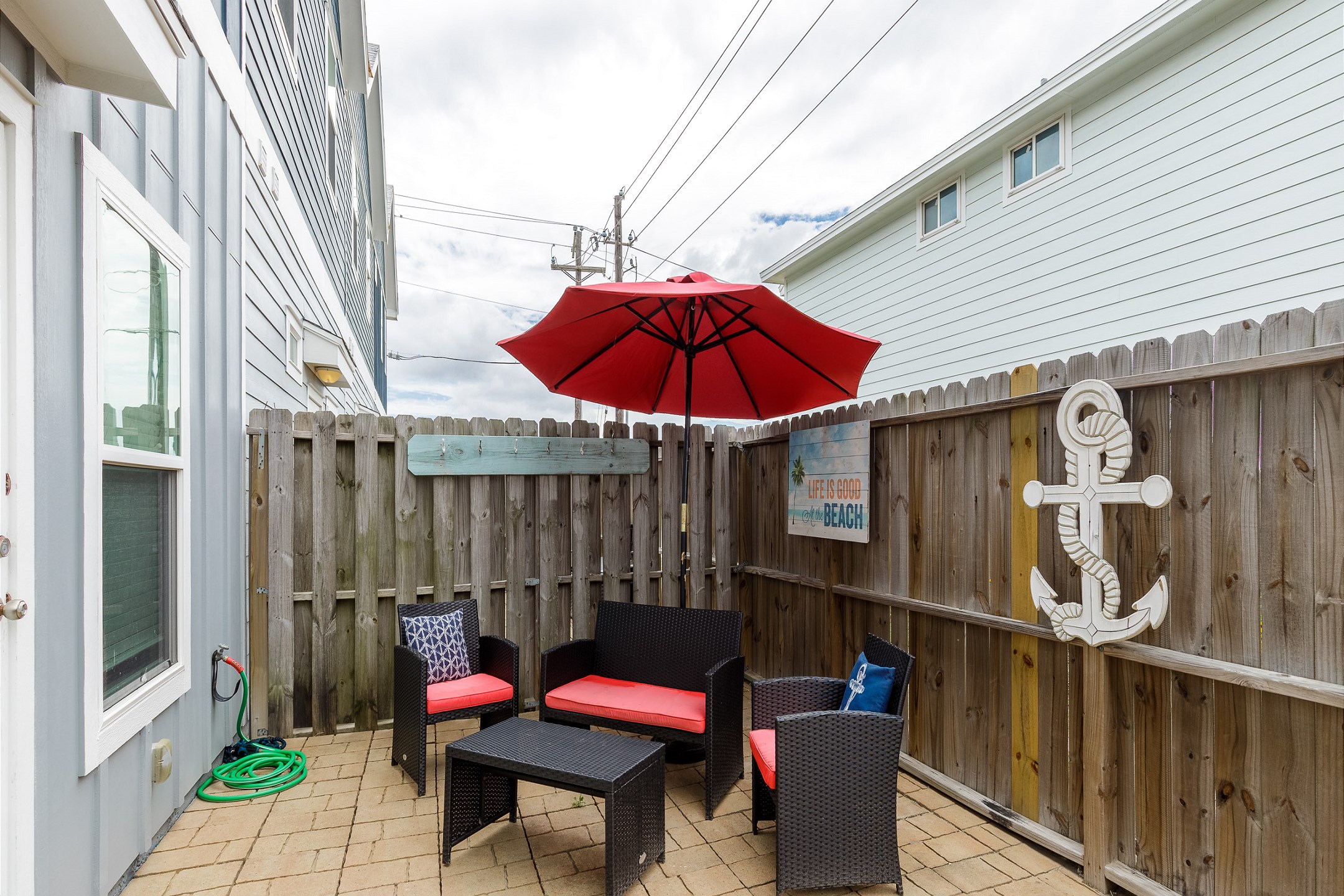 Private, fenced in patio with cozy furniture 