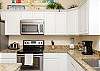 Fully equipped kitchen with stainless steel appliances and 12-cup coffee maker 