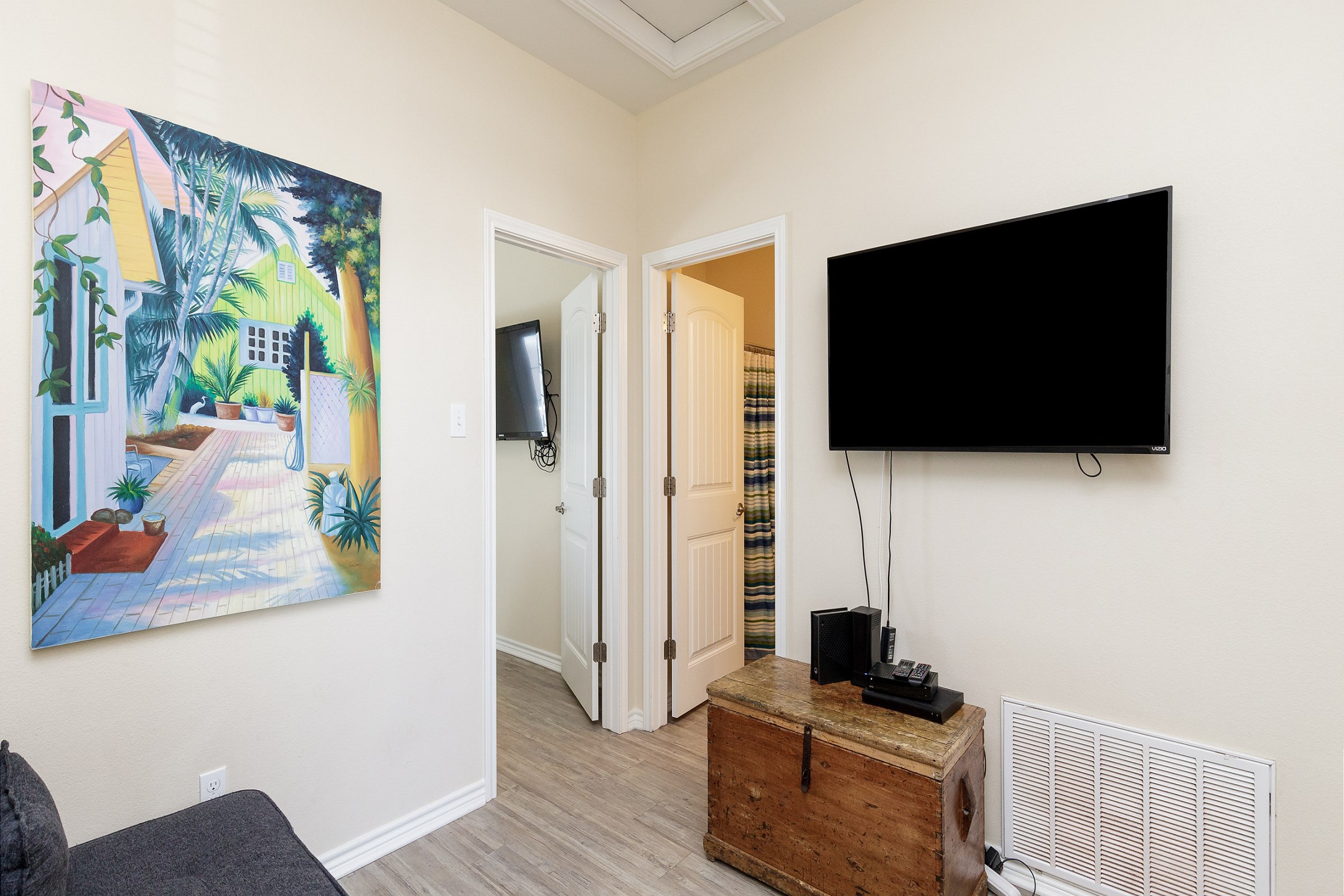 Second floor leisure space with one person futon, flat screen TV, and gaming station