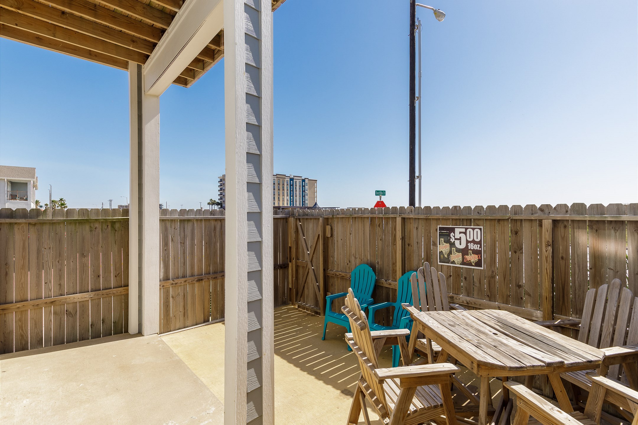 Fenced in patio area directly across the street from the beach