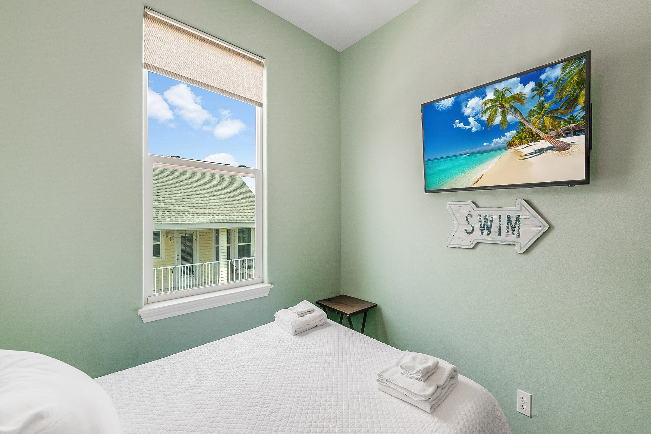Second bedroom on the second floor with king size bed, flat screen TV, and private bathroom 